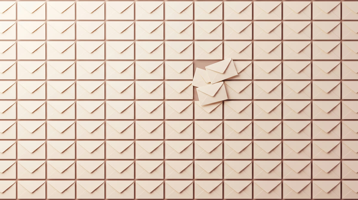 Overhead flat-lay of thousands of identical plain cream envelopes filling the frame in a grid, with 