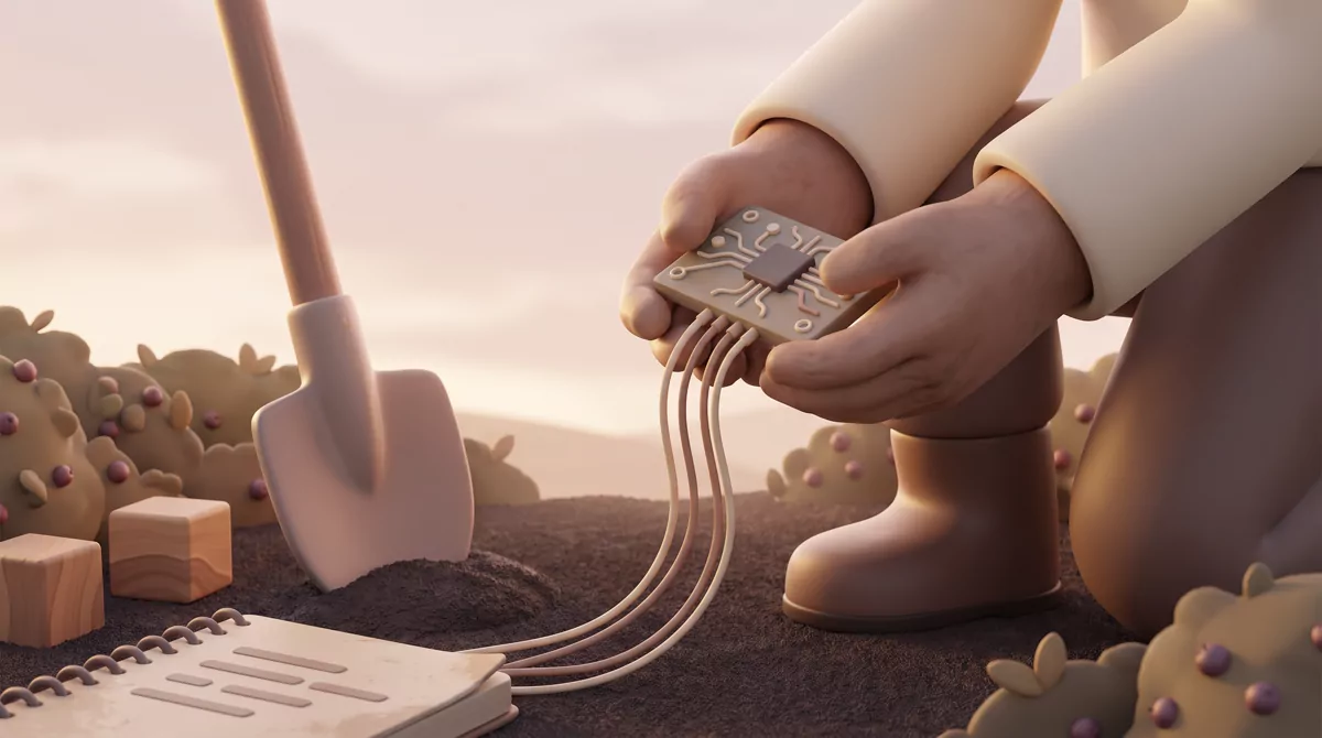 Hands holding a soil sensor board next to a shovel in a berry field.